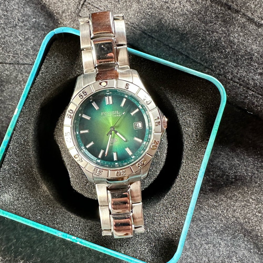 Men’s blue and green Fossil watch.